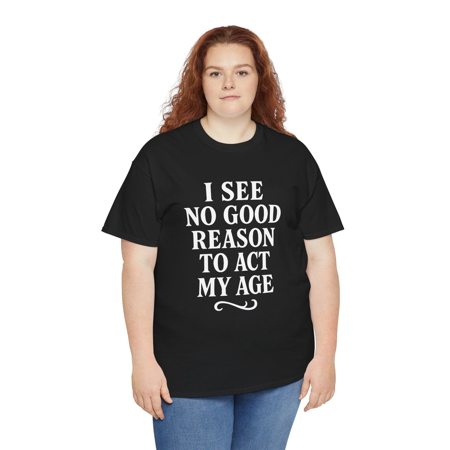 “Woman wearing black ‘I See No Good Reason To Act My Age’ humor tee, casual outfit, front view.”