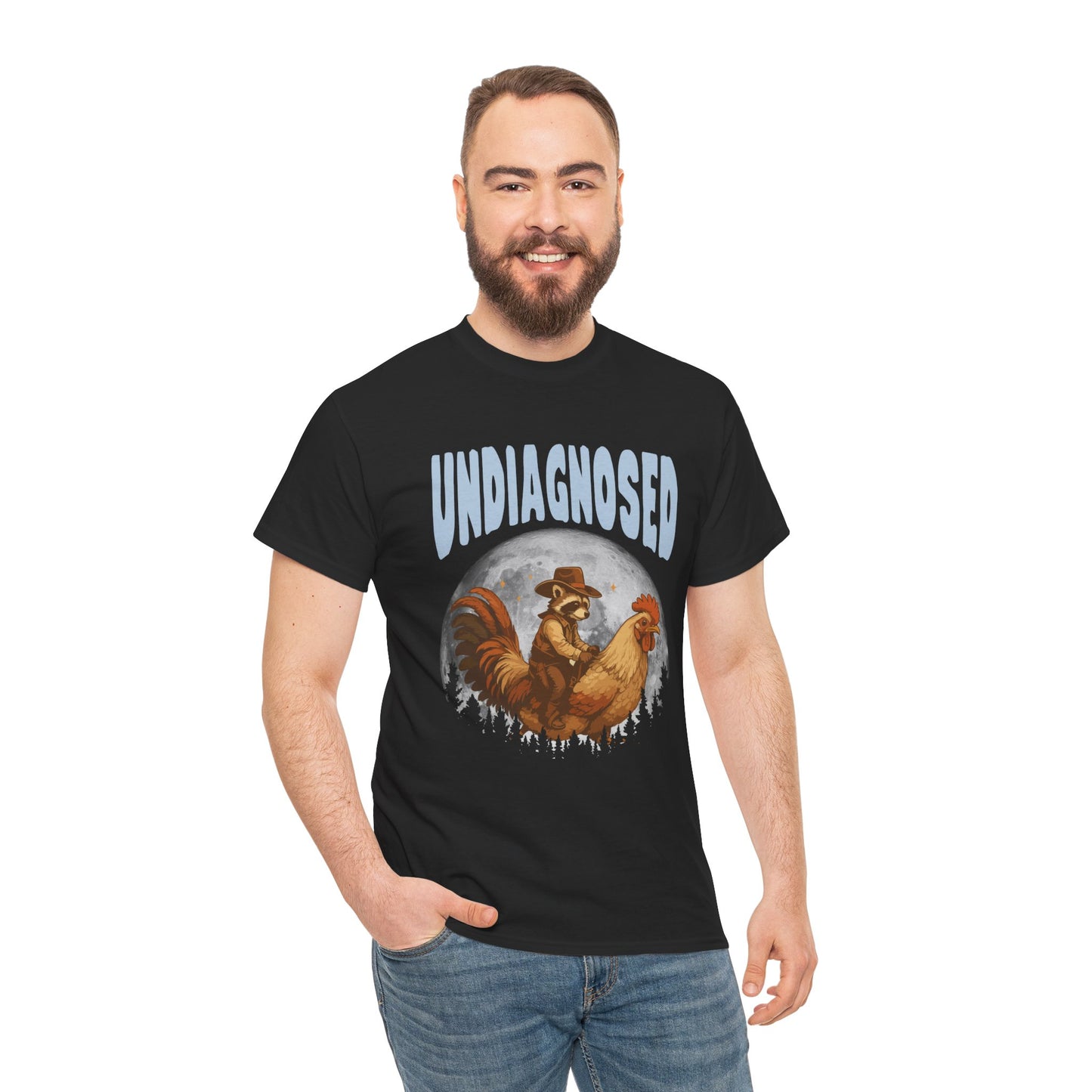 "Man wearing black 'Undiagnosed' funny western cowboy raccoon graphic t‑shirt, standing front view."