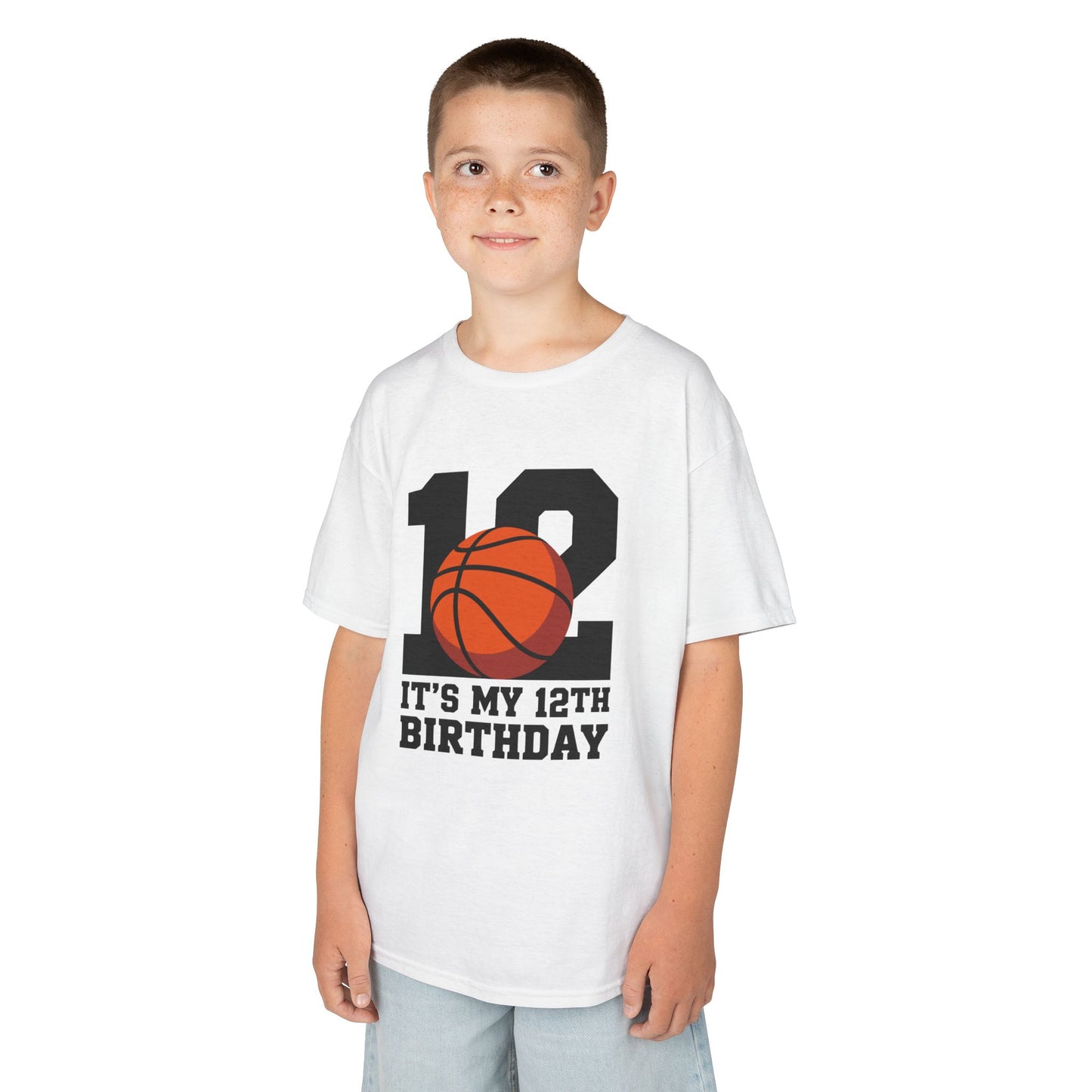 Boy White kids’ t‑shirt with big black “12” and orange basketball plus “It’s My 12th Birthday” sports graphic, flat front view.