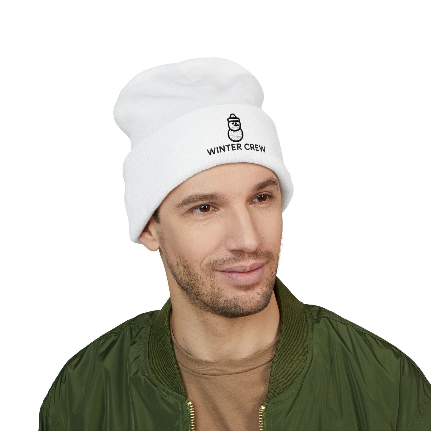 Man wearing a white beanie with 'Winter Crew' text on a white background. Soft cuffed knit hat with snowman graphic for cold-weather outfits