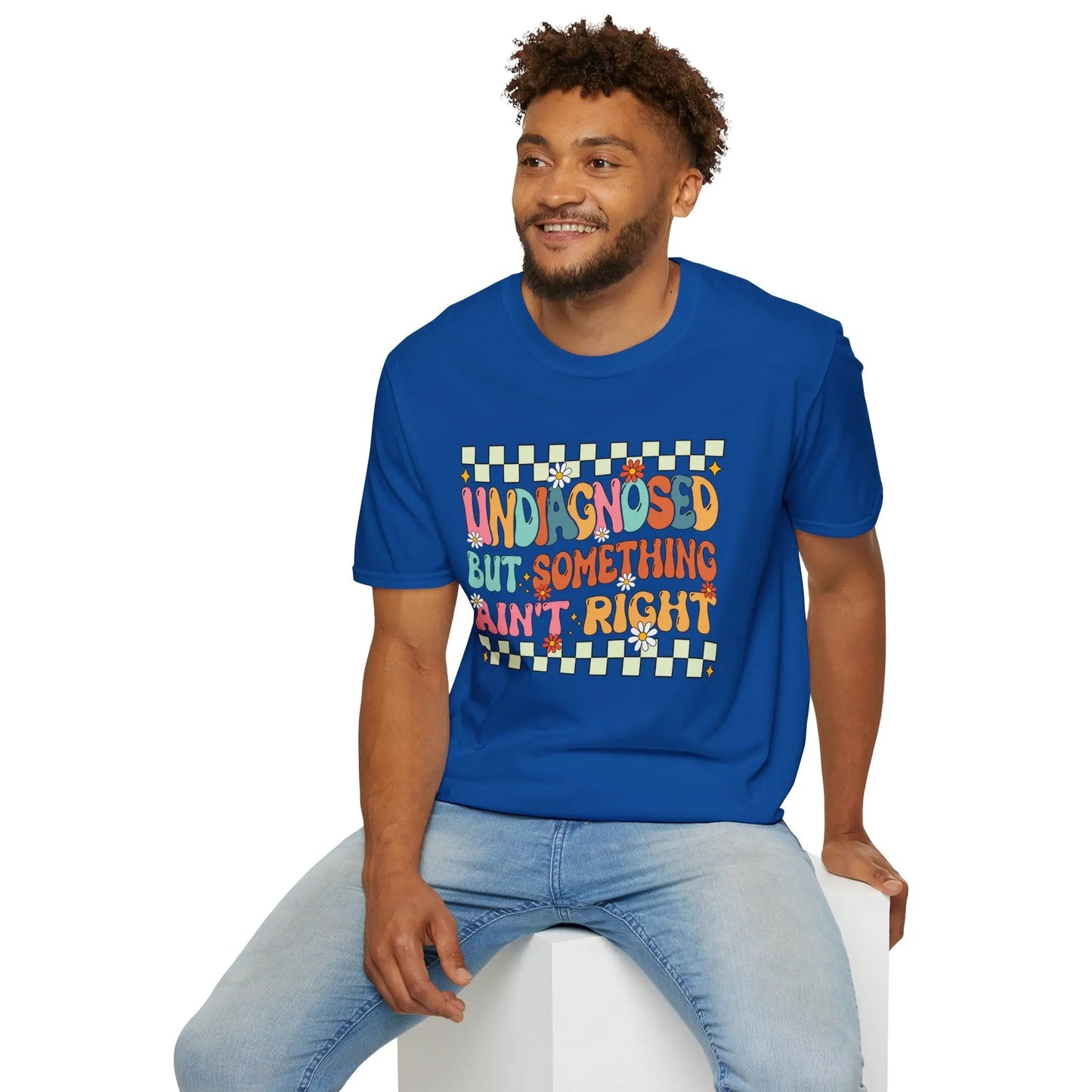 Man wearing a blue t-shirt with colorful text and graphics on a white background