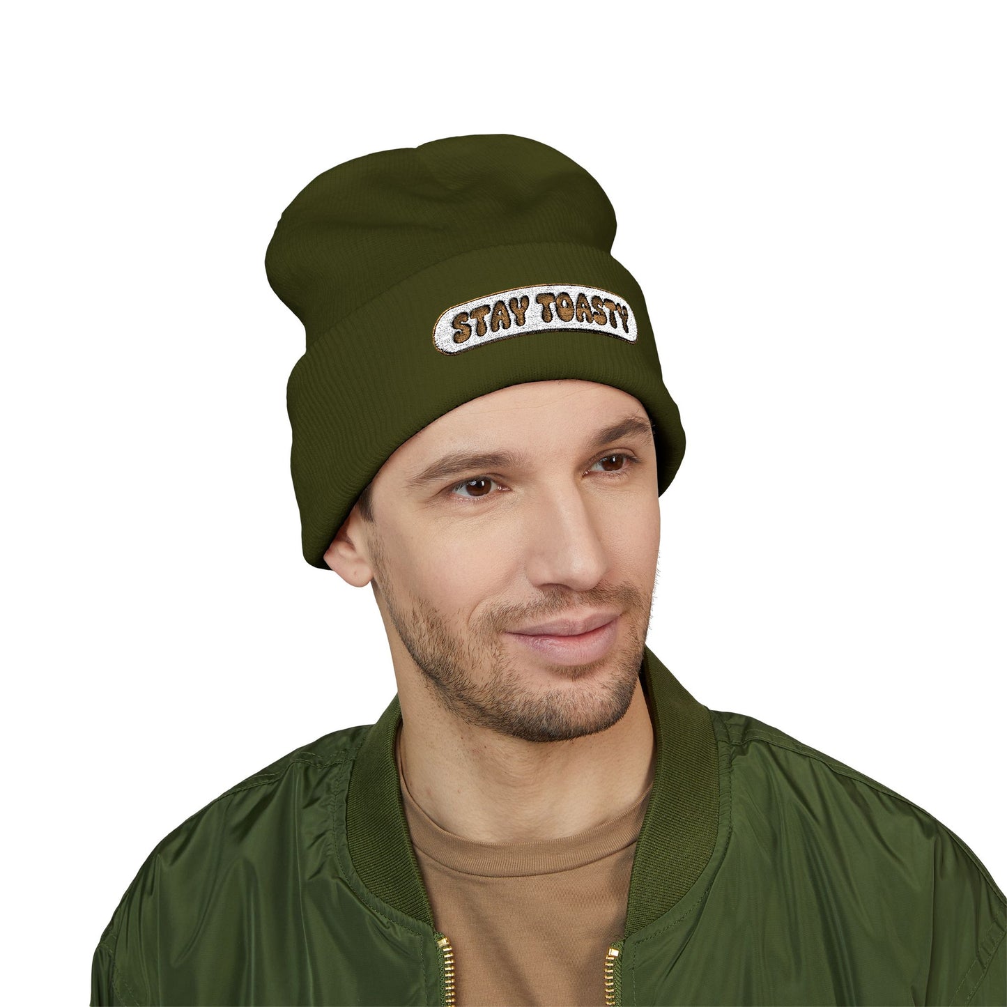Man wearing a green beanie with 'STAY TOASTY!' text on a white background