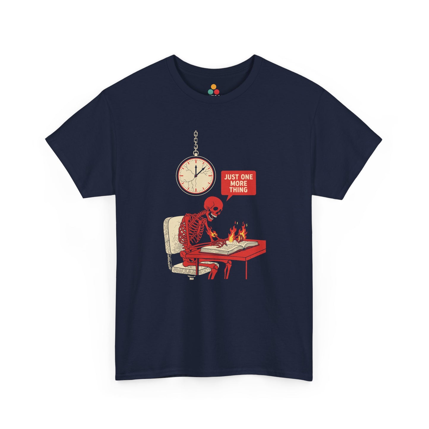 Navy Blue t‑shirt featuring a red skeleton sitting at a desk with hands on fire, writing in a book under a wall clock, with a speech bubble saying “Just One More Thing.”