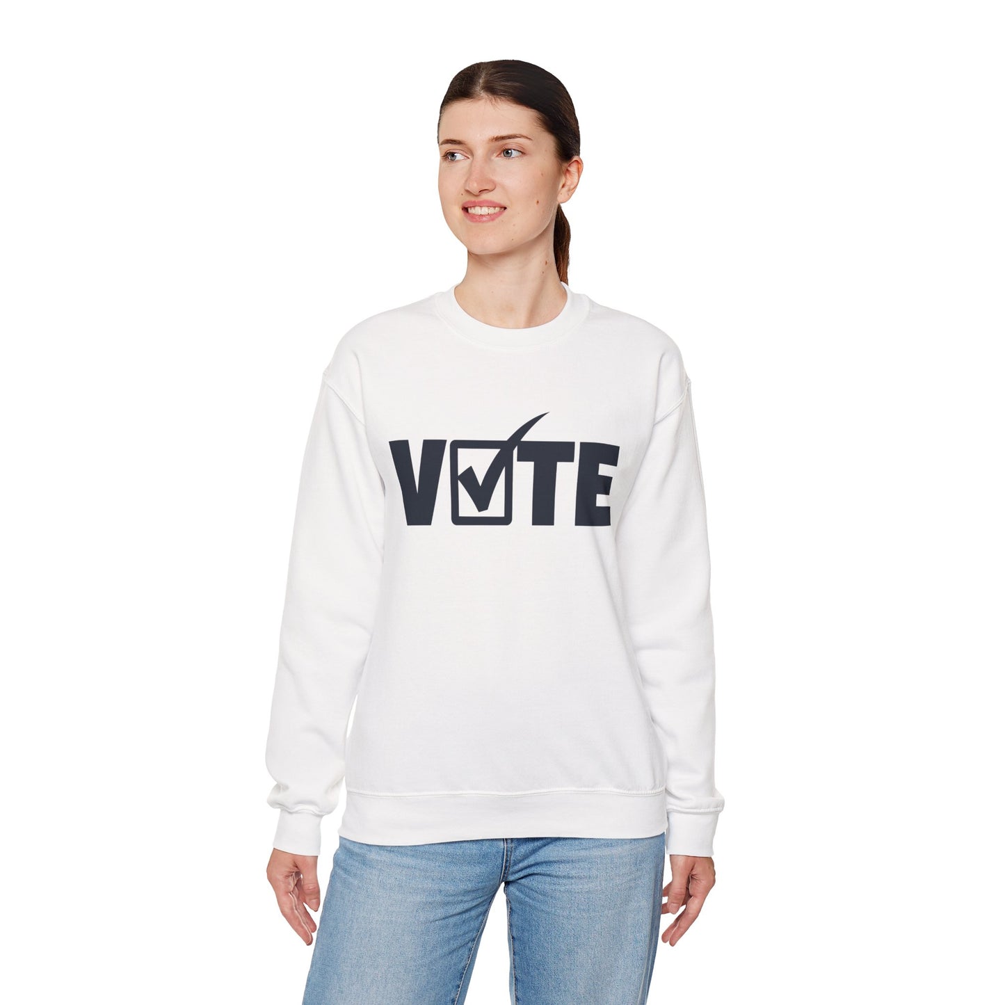 VOTE typography design with checkmark printed on TEEZOCA crewneck sweatshirt Woman wearing a white sweatshirt with 'VOTE' printed on it against a white background