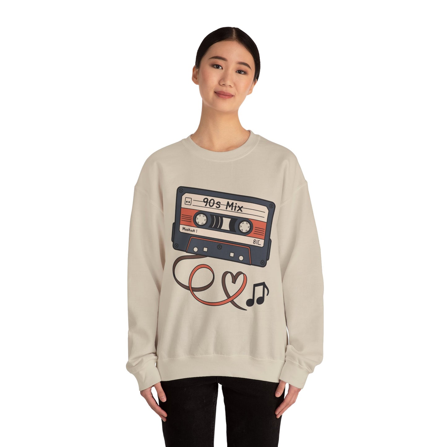 Vintage music sweatshirt featuring classic 90s cassette tape design Person wearing a beige sweatshirt with a cassette tape design on a white background