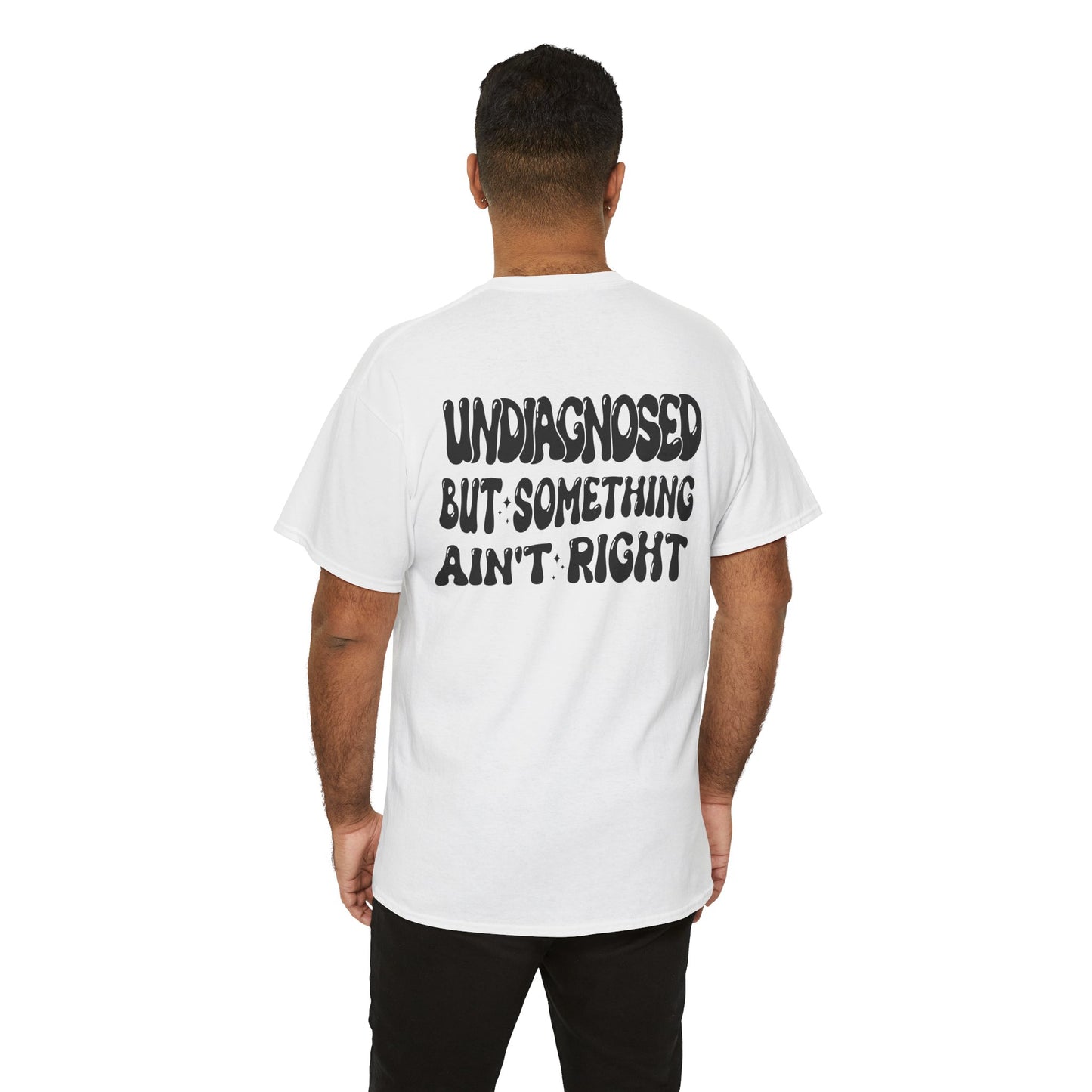 men wearing a Back Print of a white T-shirt featuring the viral meme phrase "Undiagnosed But Something Ain't Right" in bold wavy retro typography, a trending funny mental health meme shirt, unhinged humor tee, therapy meme graphic, and relatable back print statement design.