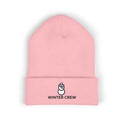 Pink beanie with 'Winter Crew' logo on a white background. Cozy winter beanie featuring cute snowman embroidery and Winter Crew text