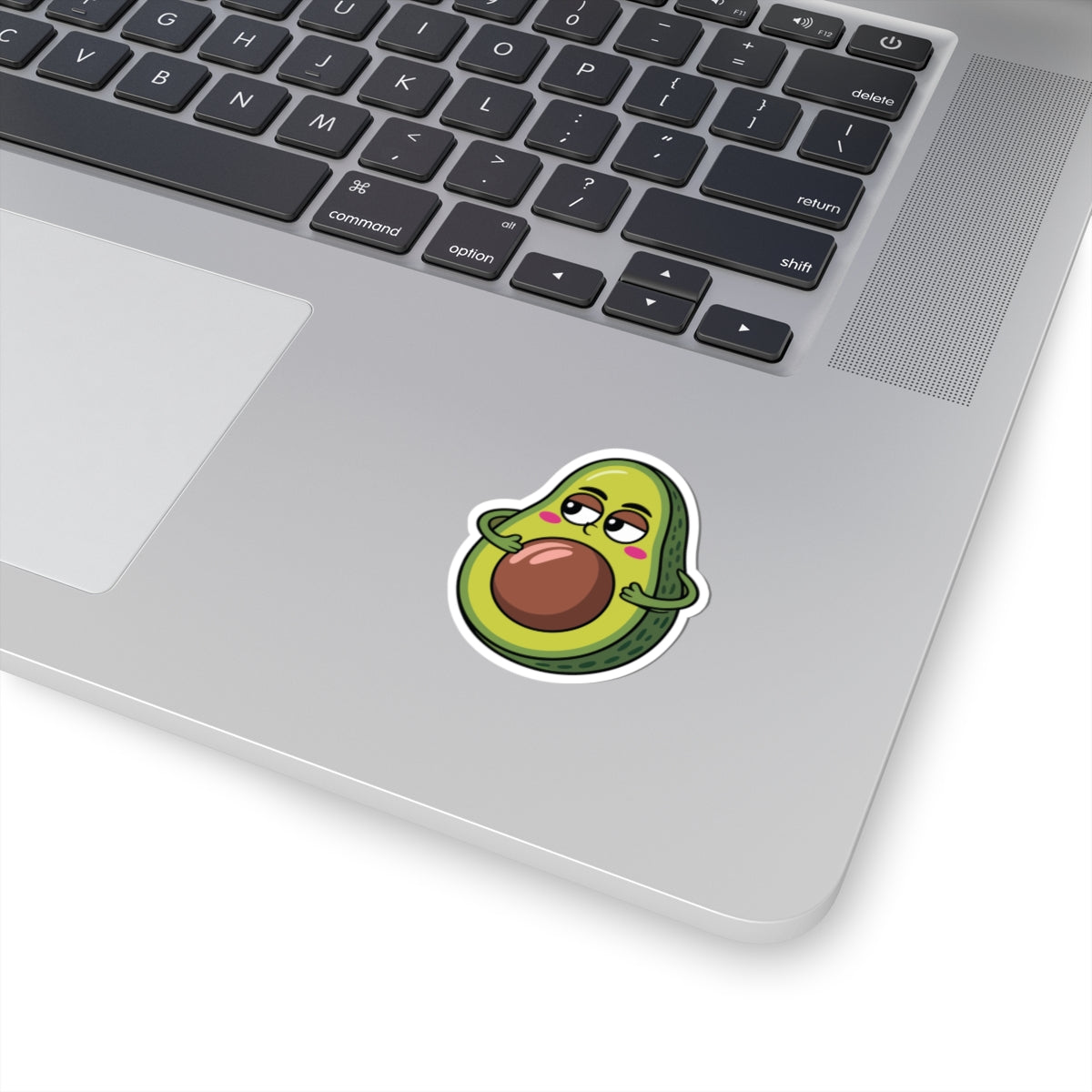 Laptop with a cute avocado sticker on the palm rest area. TEEZOCA