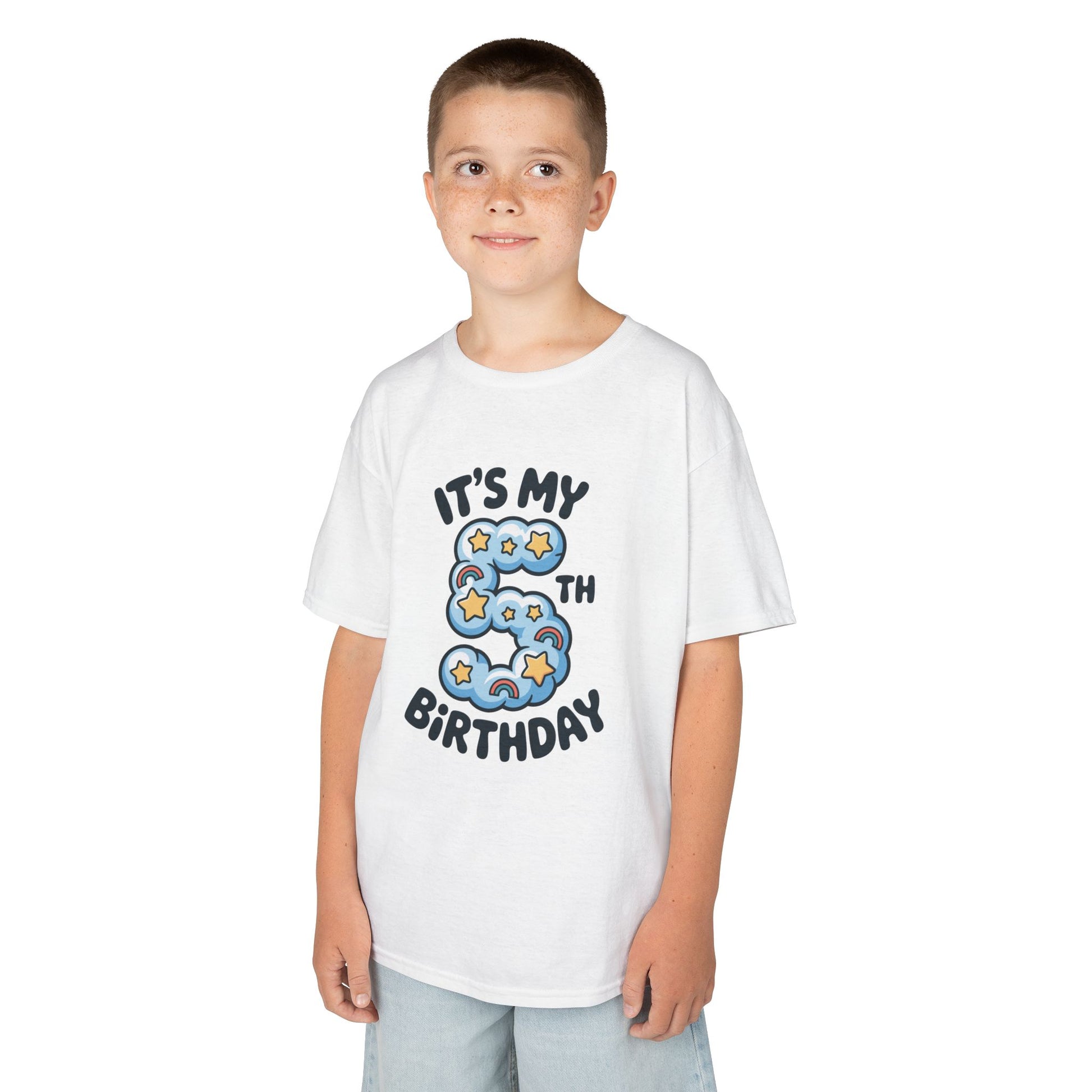Boy wearing White kids’ t‑shirt with blue cloud number 5, yellow stars, mini rainbows, and “It’s My 5th Birthday” text, flat front view.