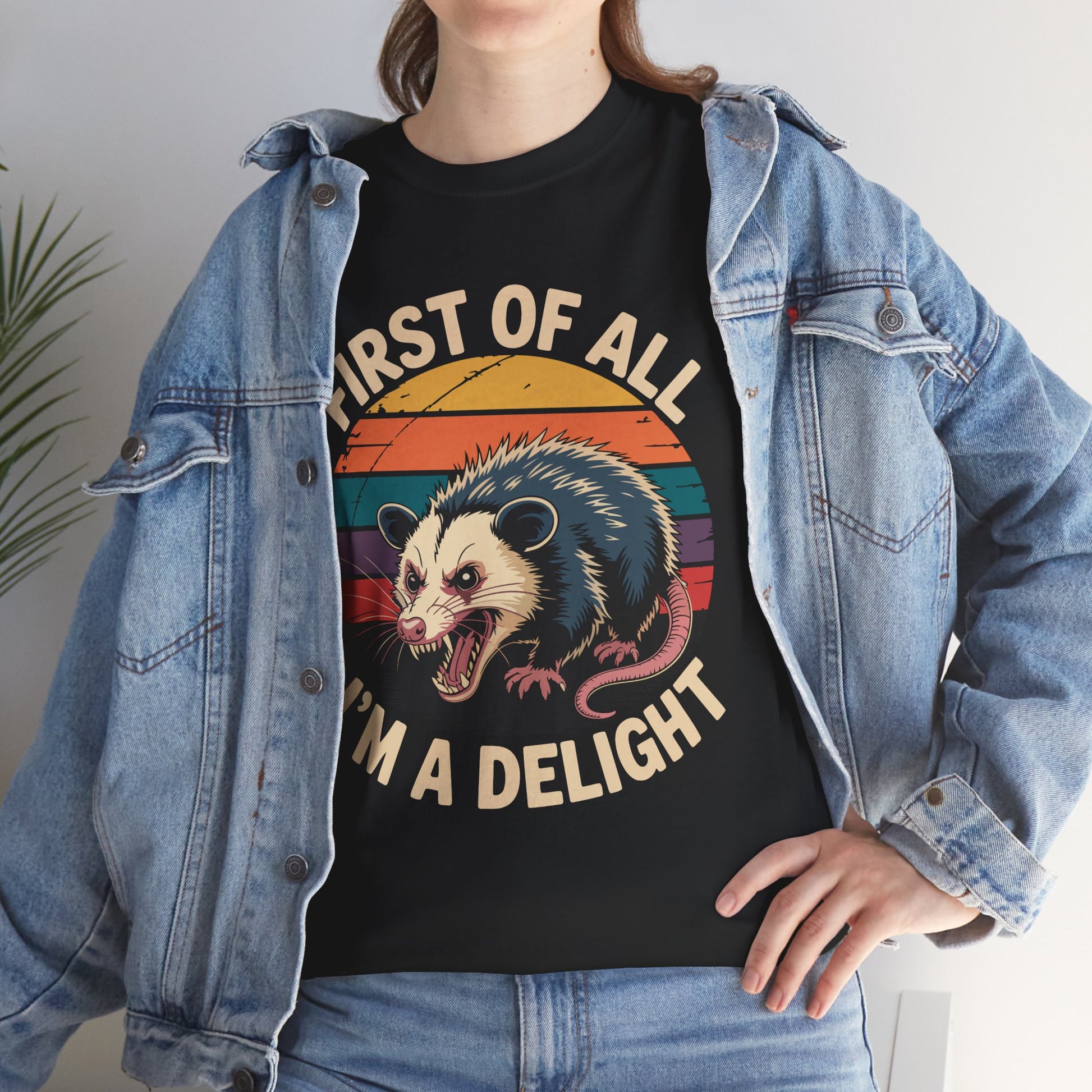 Woman in a denim jacket layering a TEEZOCA “First Of All I’m A Delight” sarcastic animal shirt.