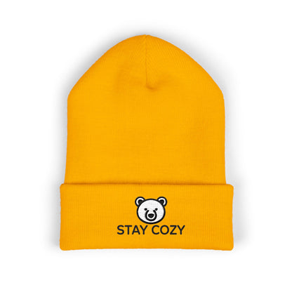 Yellow beanie with 'Stay Cozy' logo on a white background