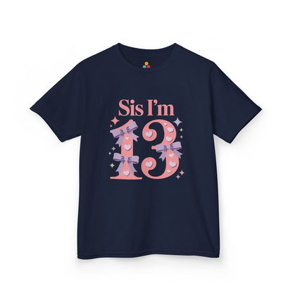  Navy t‑shirt with pink “Sis I’m 13” design featuring hearts, lilac bows, and sparkles, flat front view.