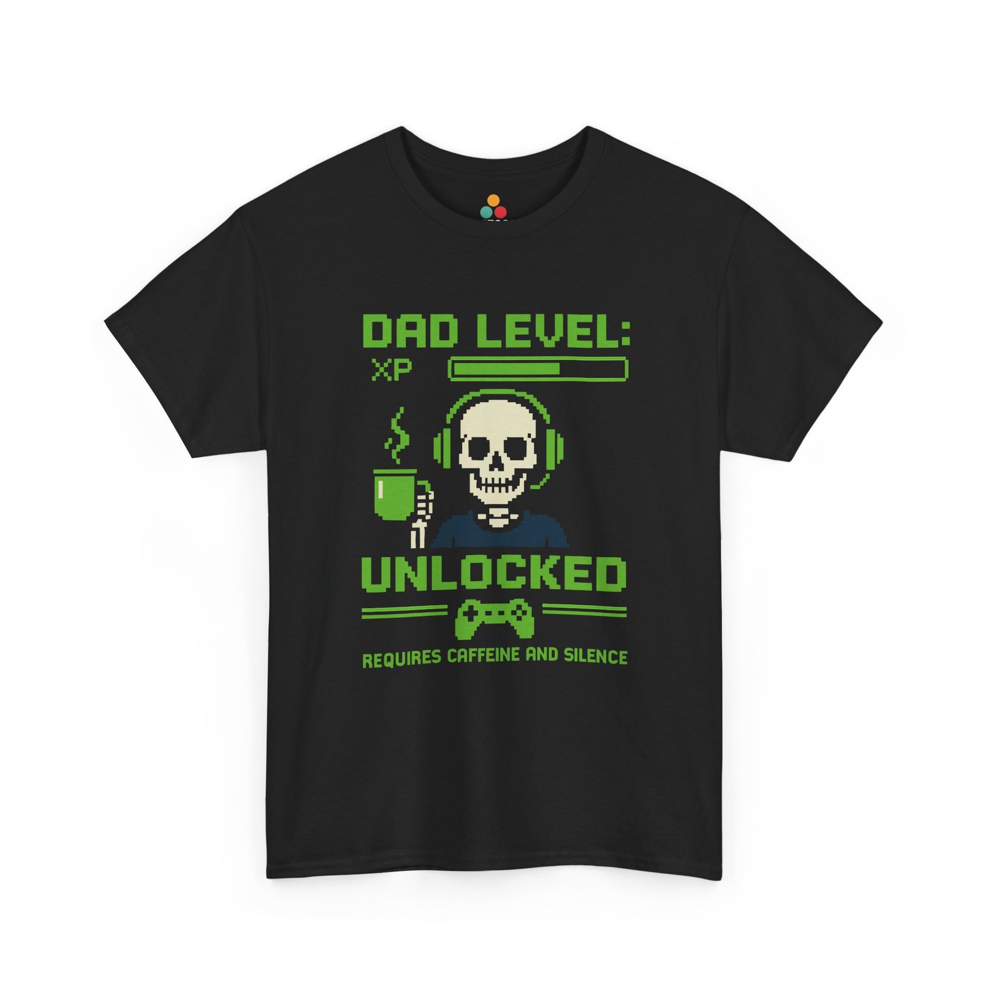 “Black t‑shirt with green pixel art skull in headset holding a coffee mug and text ‘Dad Level: XP Unlocked – Requires Caffeine and Silence’, flat front view.”

