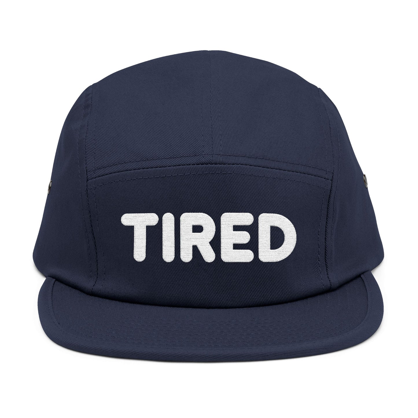 Navy blue cap with 'TIRED' text on a white background. TIRED minimalist text embroidered on 5-panel cap by TEEZOCA