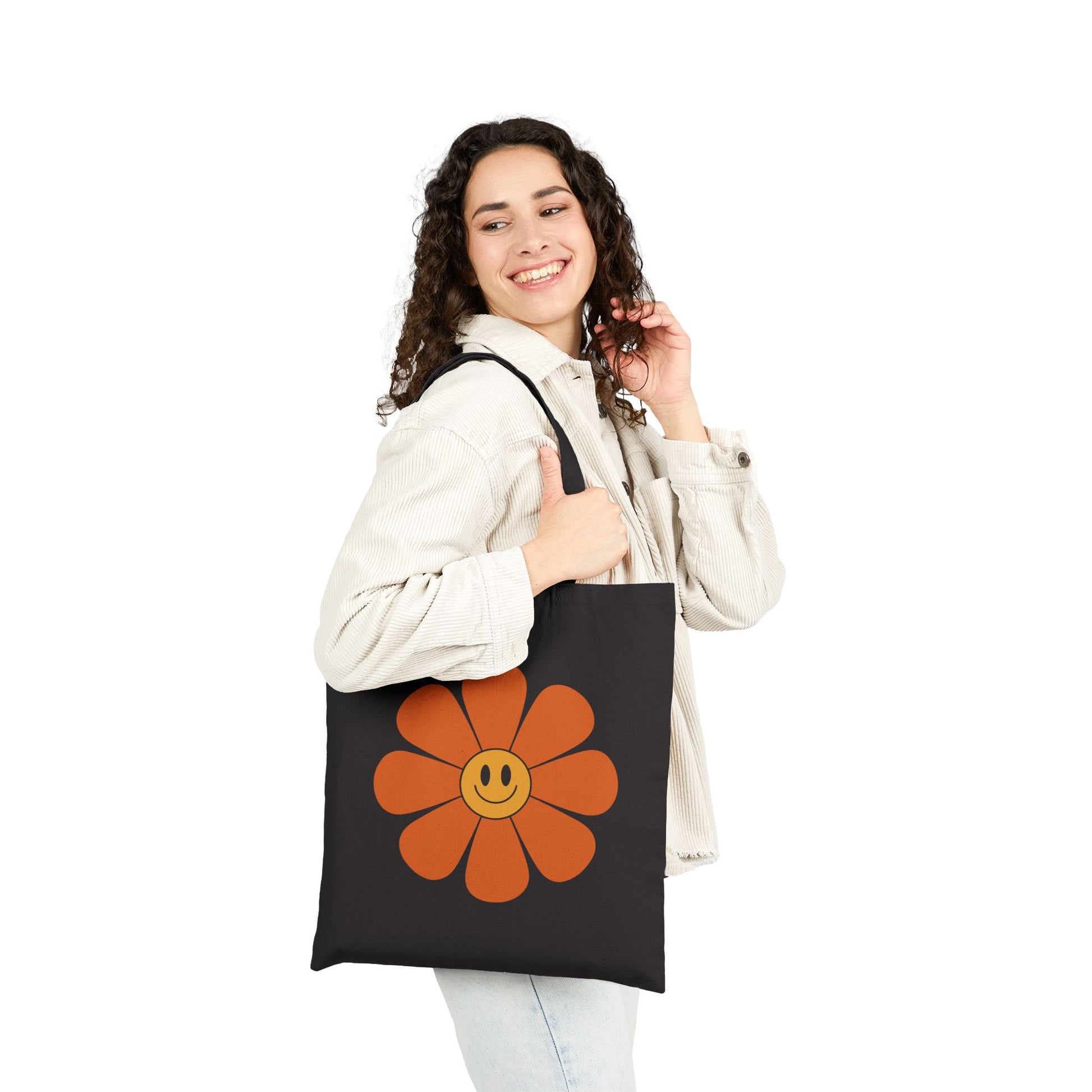 Happy flower graphic with orange petals printed on a TEEZOCA tote bag