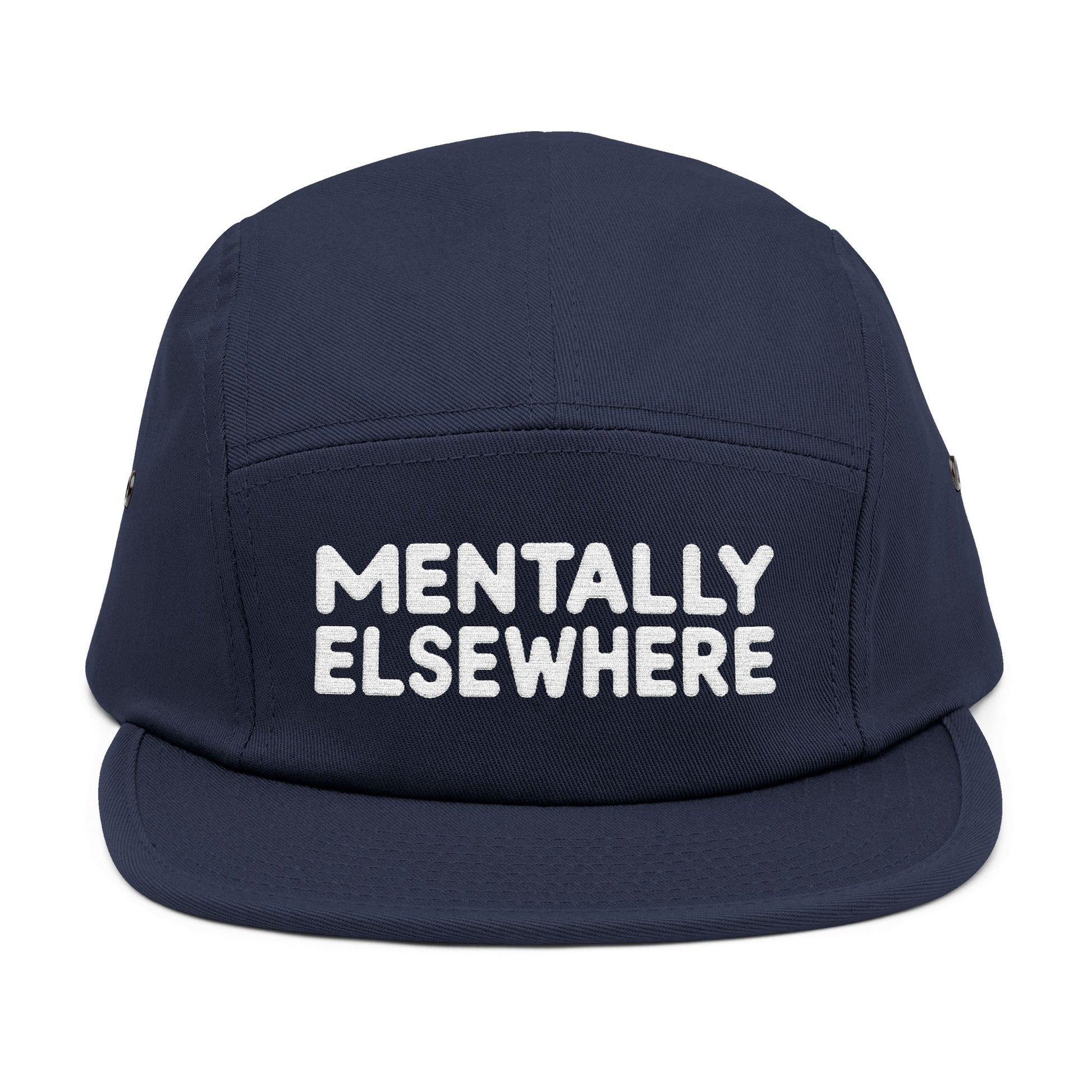 Navy blue cap with 'MENTALLY ELSEWHERE' text on a white background. Mentally Elsewhere embroidered text design on five-panel cap. TEEZOCA