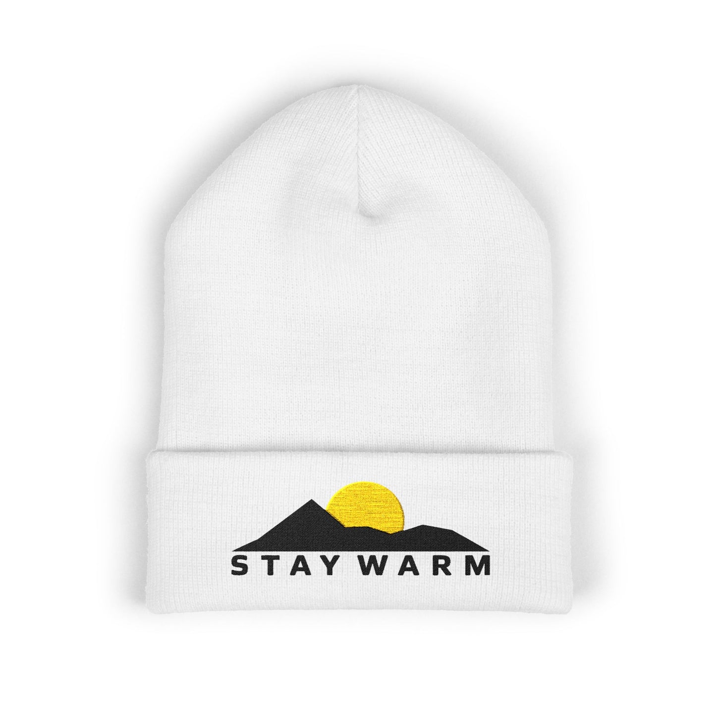 White beanie with 'Stay Warm' design featuring mountains and a sun on a white background