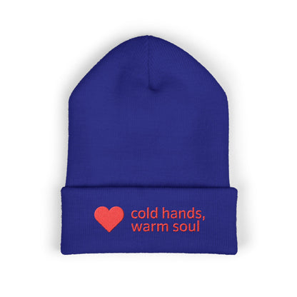Blue beanie with red heart and text 'cold hands, warm soul' on a white background