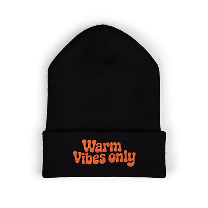 Black beanie with 'Warm Vibes only' text in orange on a white background. “Warm vibes only” embroidered patch on cozy cuffed beanie in retro orange thread.