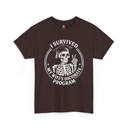 Brown TEEZOCA “I Survived My Wife’s Doctorate Program” skeleton grad graphic t‑shirt displayed flat.