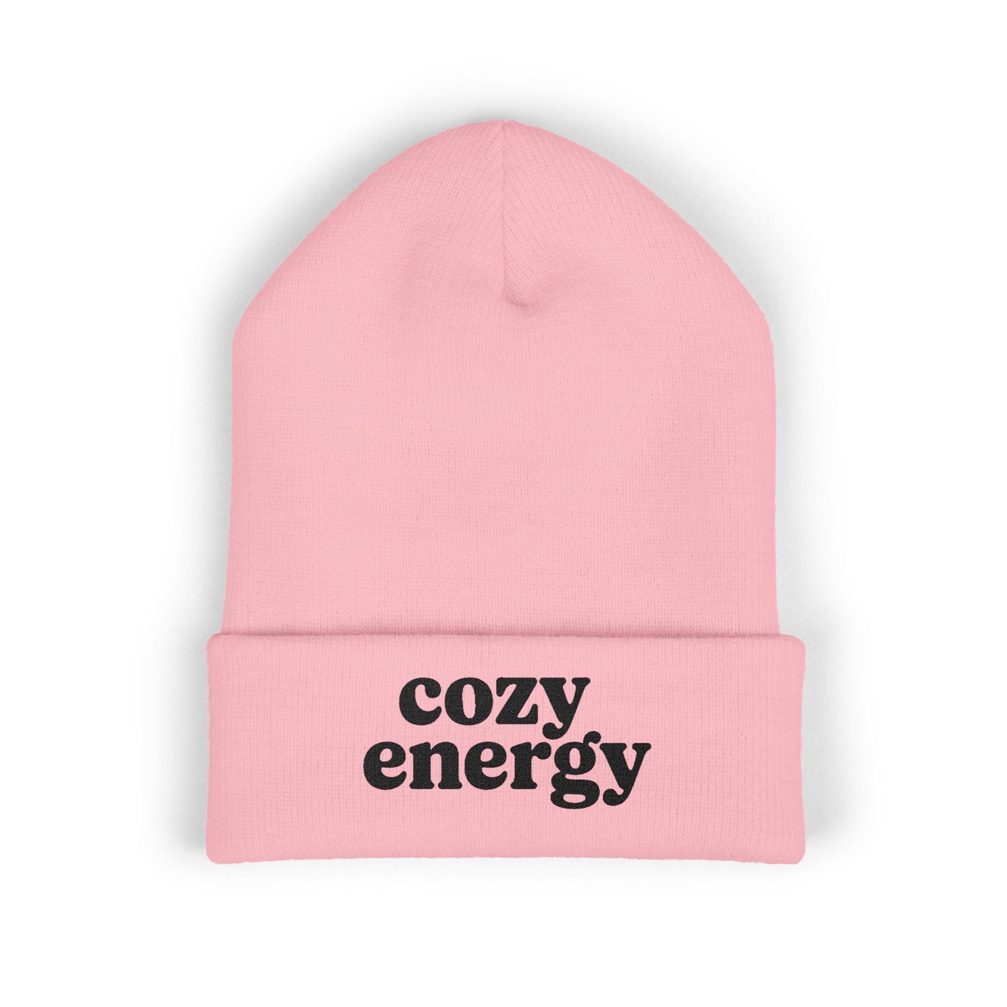 Pink beanie with 'cozy energy' text on a white background