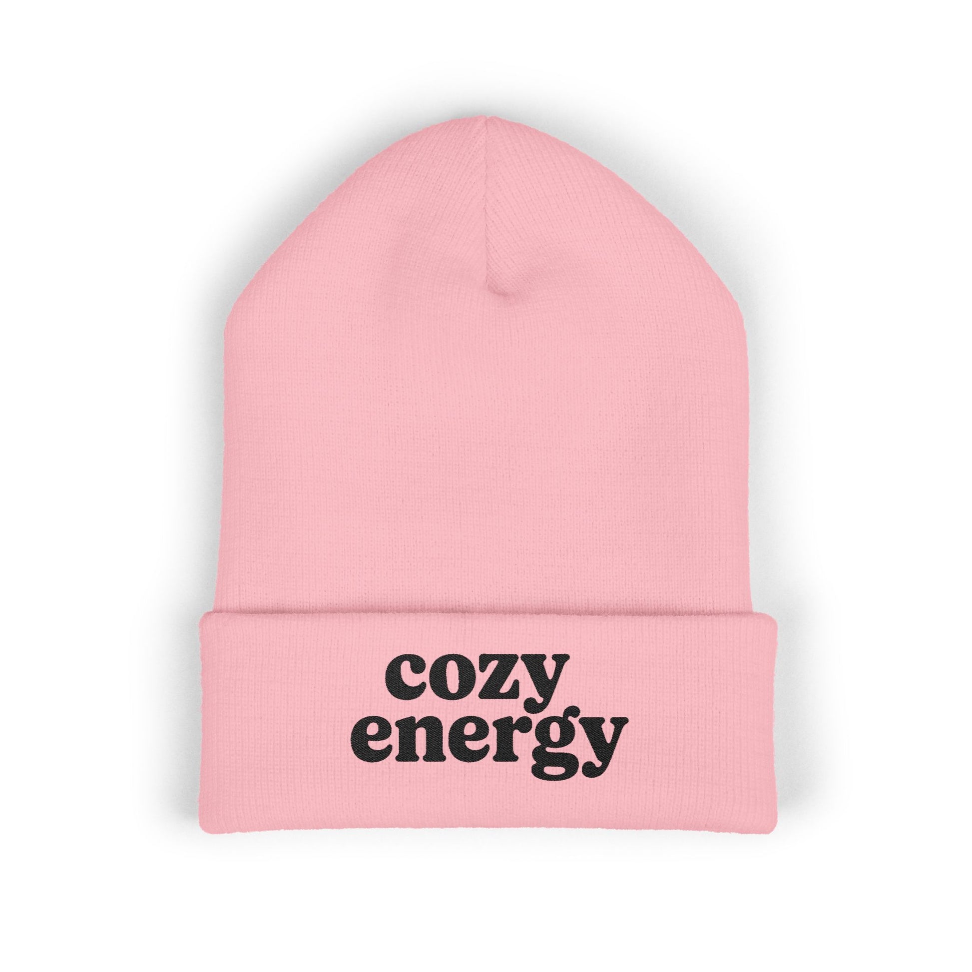 Pink beanie with 'cozy energy' text on a white background