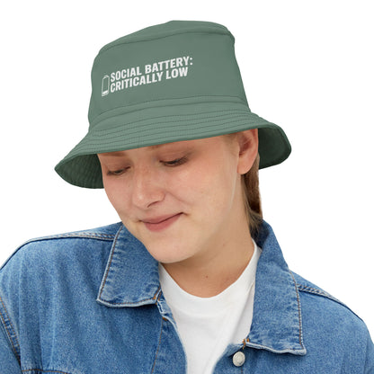 Green bucket hat with funnt text 'Social Battery: Critically Low' on a white background. TEEZOCA