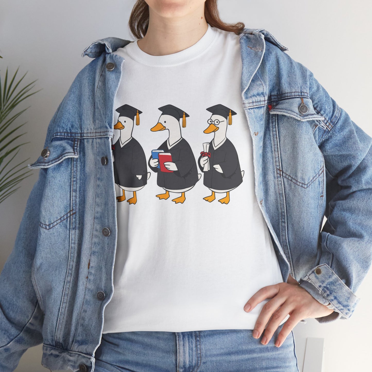 Woman in a denim jacket styling a white TEEZOCA graduation ducks t‑shirt.