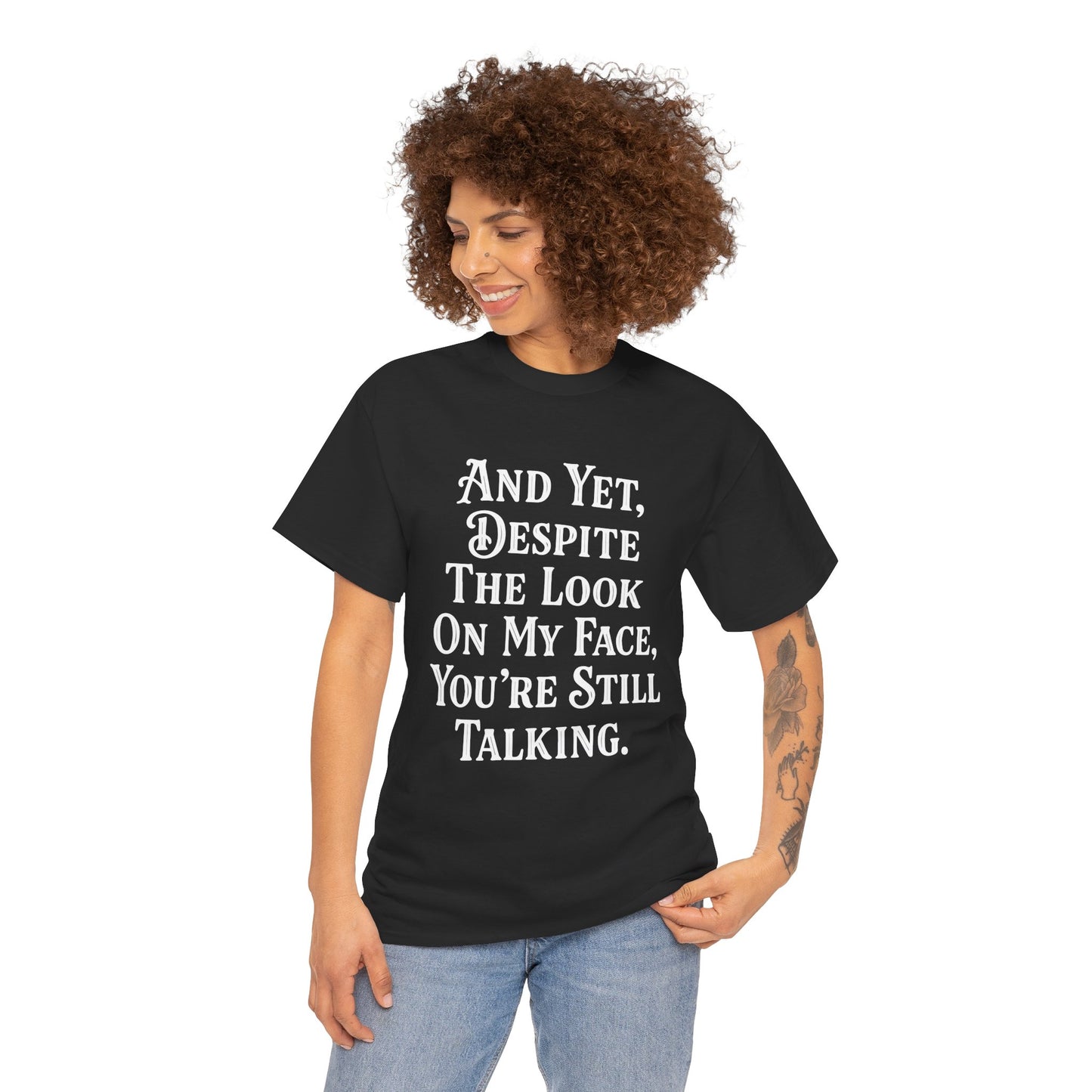 “Female model wearing Teezoca And Yet Despite the Look on My Face You’re Still Talking t-shirt, sarcastic quote design, black unisex tee, front.”

