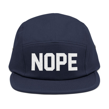 Navy blue cap with 'NOPE' text on a white background. NOPE bold minimal typography embroidery design on cap. TEEZOCA