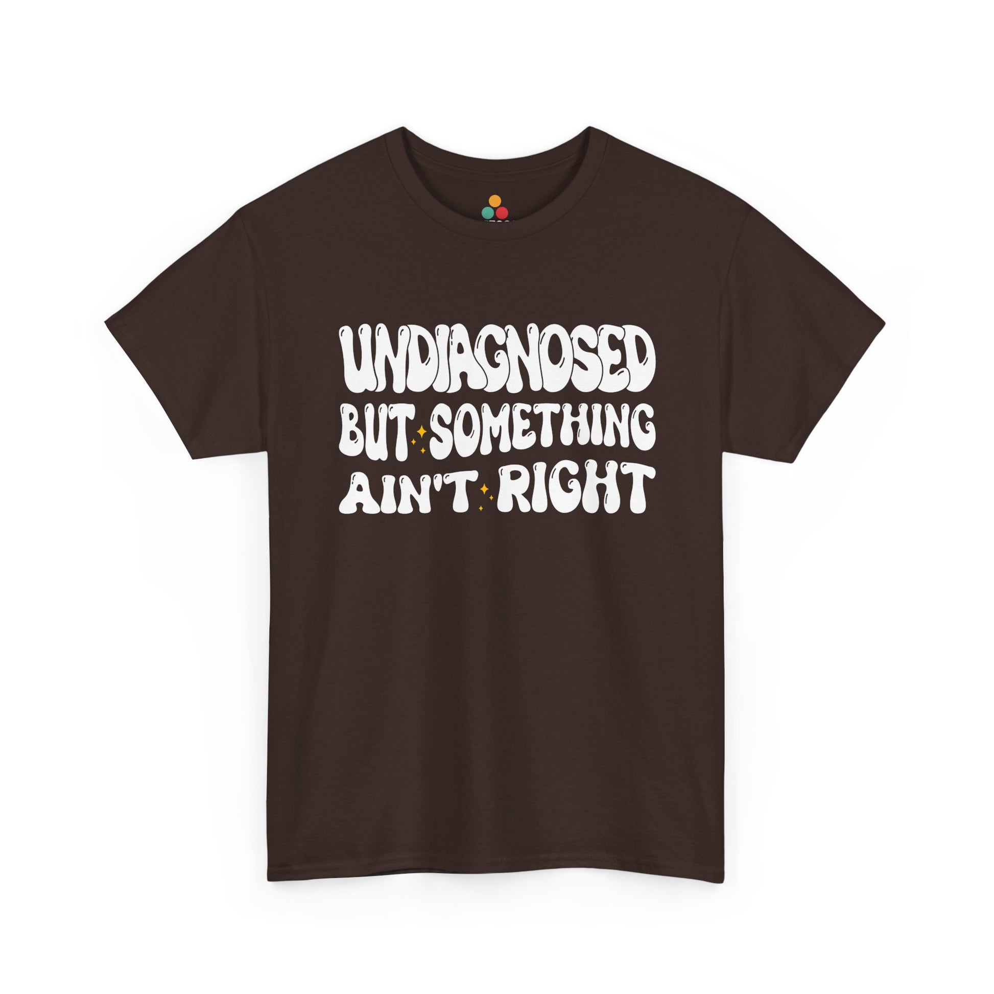 “Teezoca Undiagnosed But Something Ain’t Right t-shirt, retro typography graphic, dark brown tee, front view.”​


