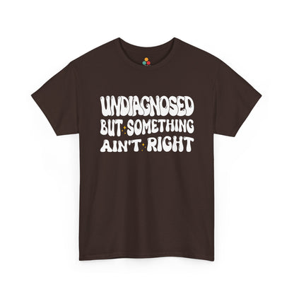 “Teezoca Undiagnosed But Something Ain’t Right t-shirt, retro typography graphic, dark brown tee, front view.”​

