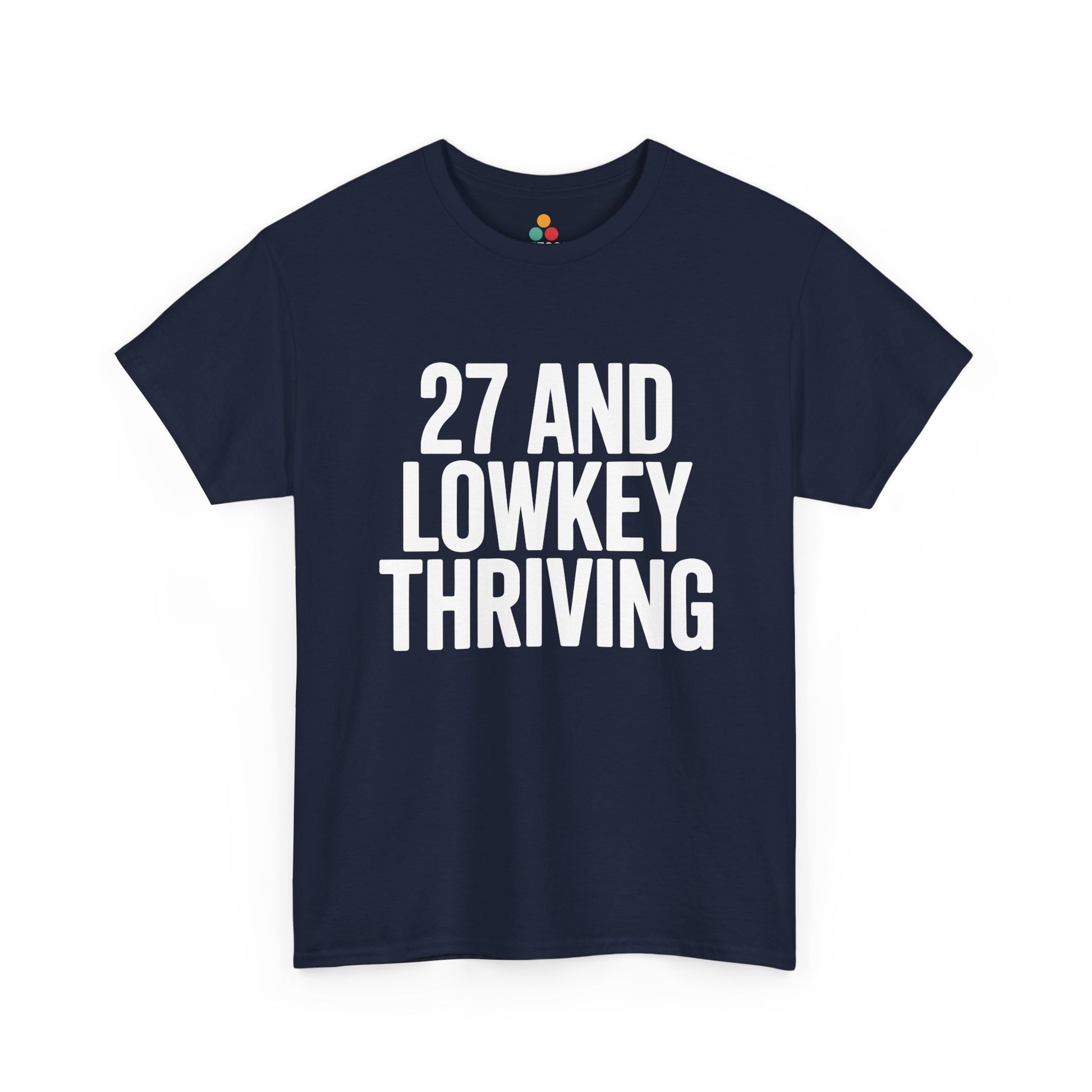 Navy blue t-shirt with white text '27 AND LOWKEY THRIVING' on a white background