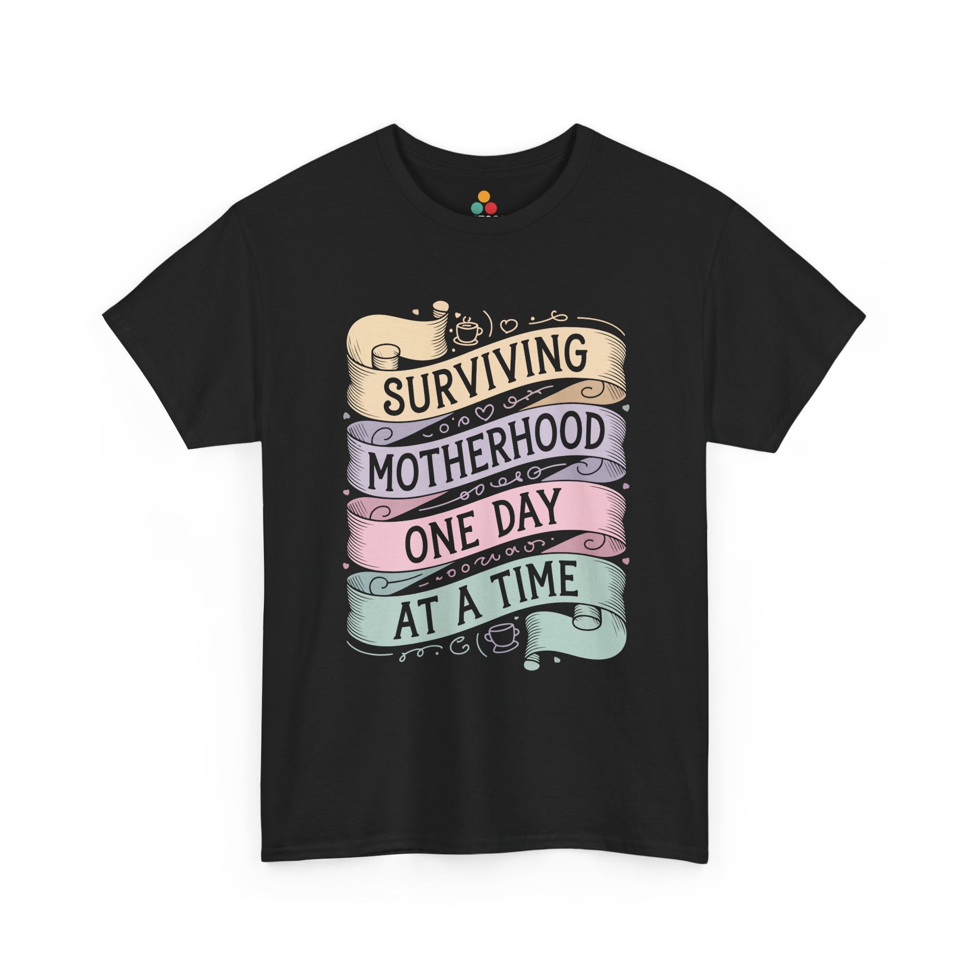 TEEZOCA black “Surviving Motherhood One Day At A Time” pastel banner t‑shirt shown flat.