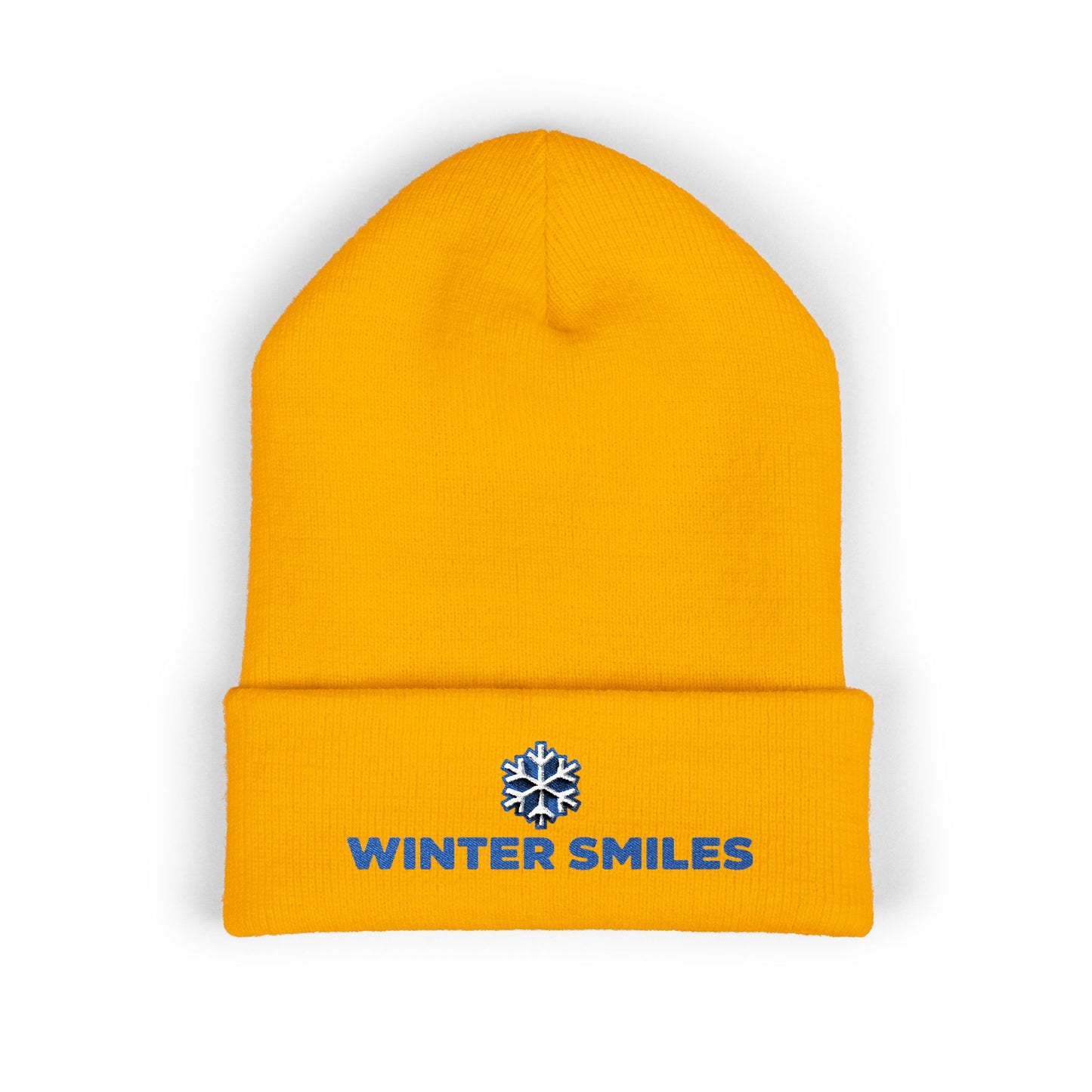 Yellow beanie with 'Winter Smiles' logo on a white background. Close-up of snowflake embroidery on cozy winter knit hat