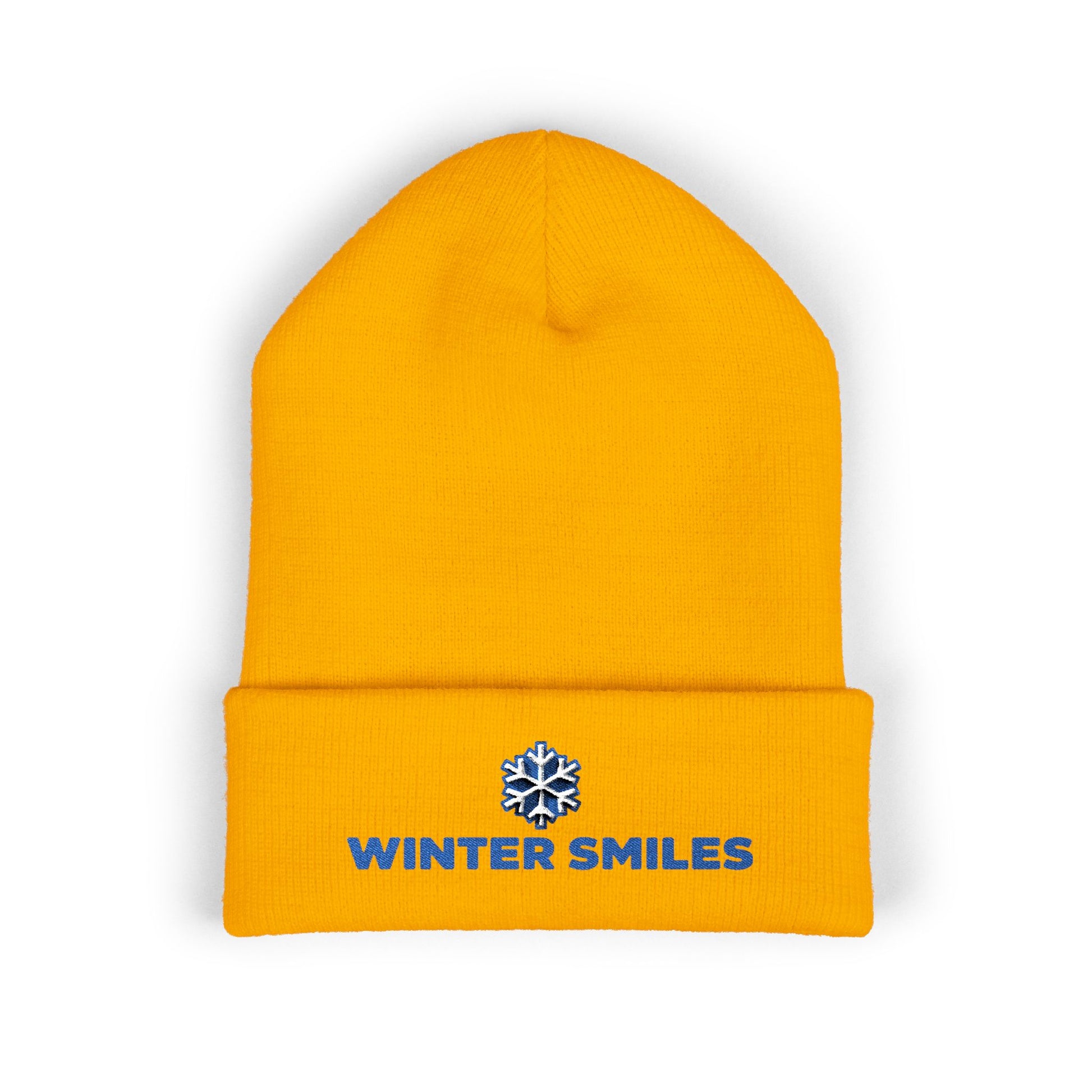 Yellow beanie with 'Winter Smiles' logo on a white background. Close-up of snowflake embroidery on cozy winter knit hat