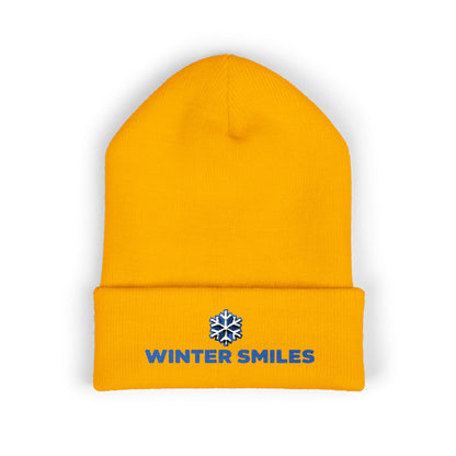 Yellow beanie with 'Winter Smiles' logo on a white background. Close-up of snowflake embroidery on cozy winter knit hat