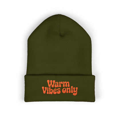 Green beanie with 'Warm Vibes only' text in orange on a white background. Playful retro-style beanie with warm orange lettering stitched on cuff.
