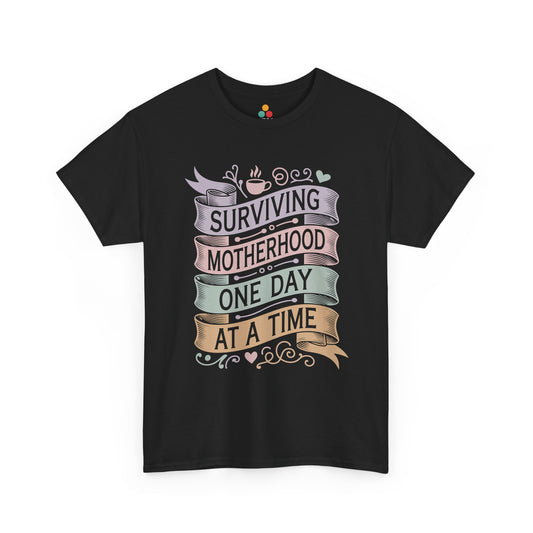 TEEZOCA black "Surviving Motherhood One Day At A Time" vintage banner graphic t‑shirt shown flat.
