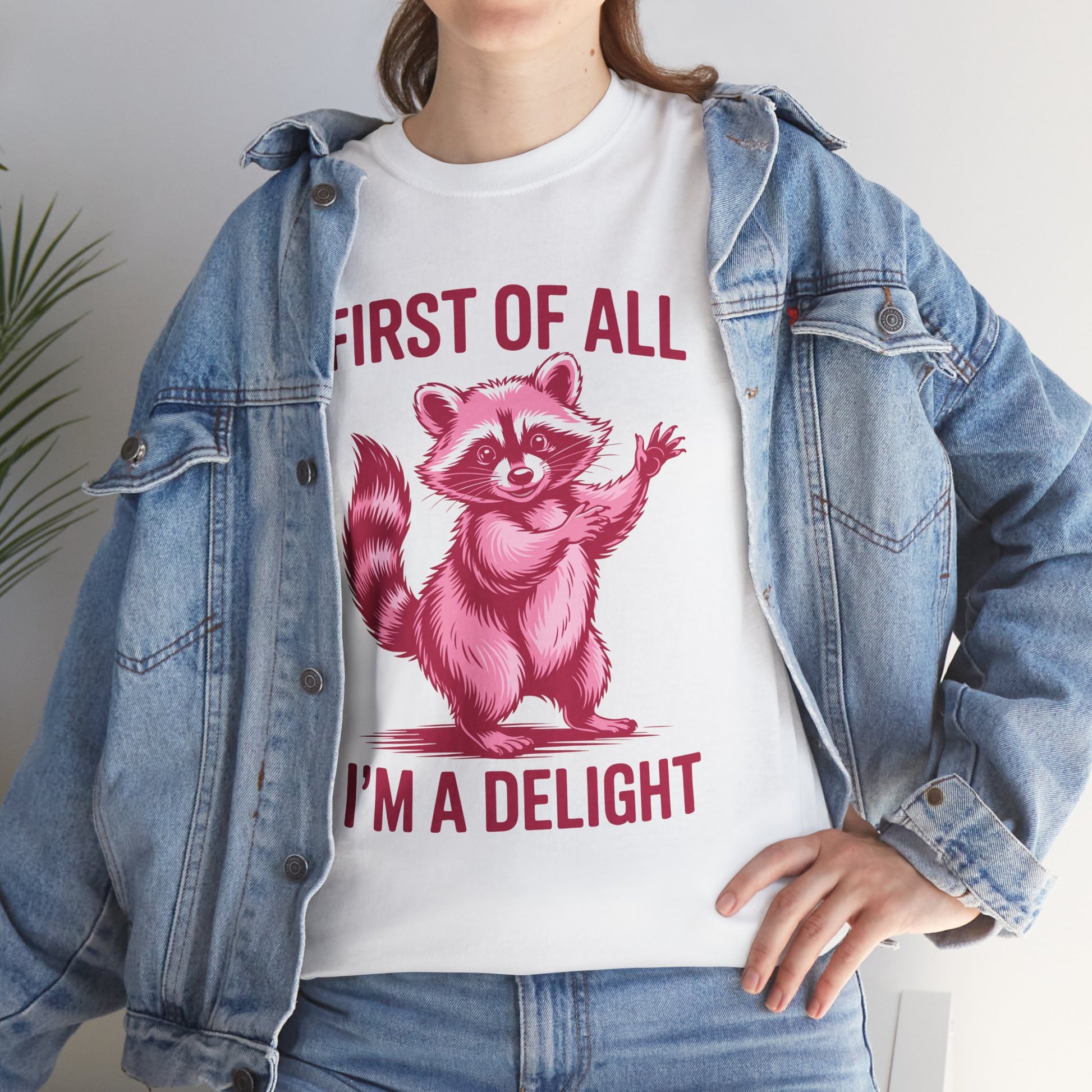 Woman in a denim jacket wearing a TEEZOCA “First Of All I’m A Delight” cute raccoon tee.