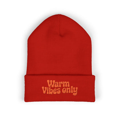 Red beanie with 'Warm Vibes only' text on a white background. Soft cuffed beanie featuring optimistic “Warm vibes only” embroidery.