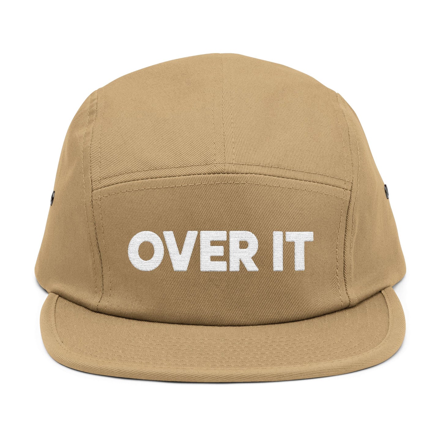 Beige cap with 'OVER IT' text on a white background. OVER IT embroidered text design displayed on clean white typography. TEEZOCA