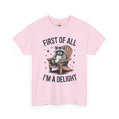 TEEZOCA pink “First Of All I’m A Delight” cute lounging raccoon tee shown flat.