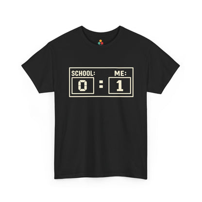 Black TEEZOCA t‑shirt with “SCHOOL: 0 ME: 1” scoreboard design shown flat.