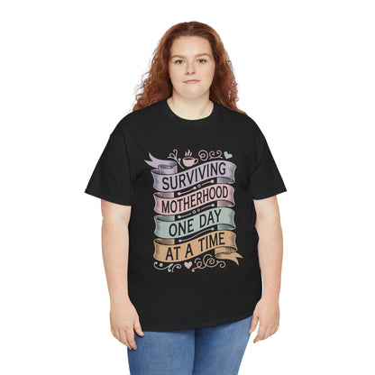 Woman wearing a black TEEZOCA "Surviving Motherhood One Day At A Time" funny mom tee with jeans.