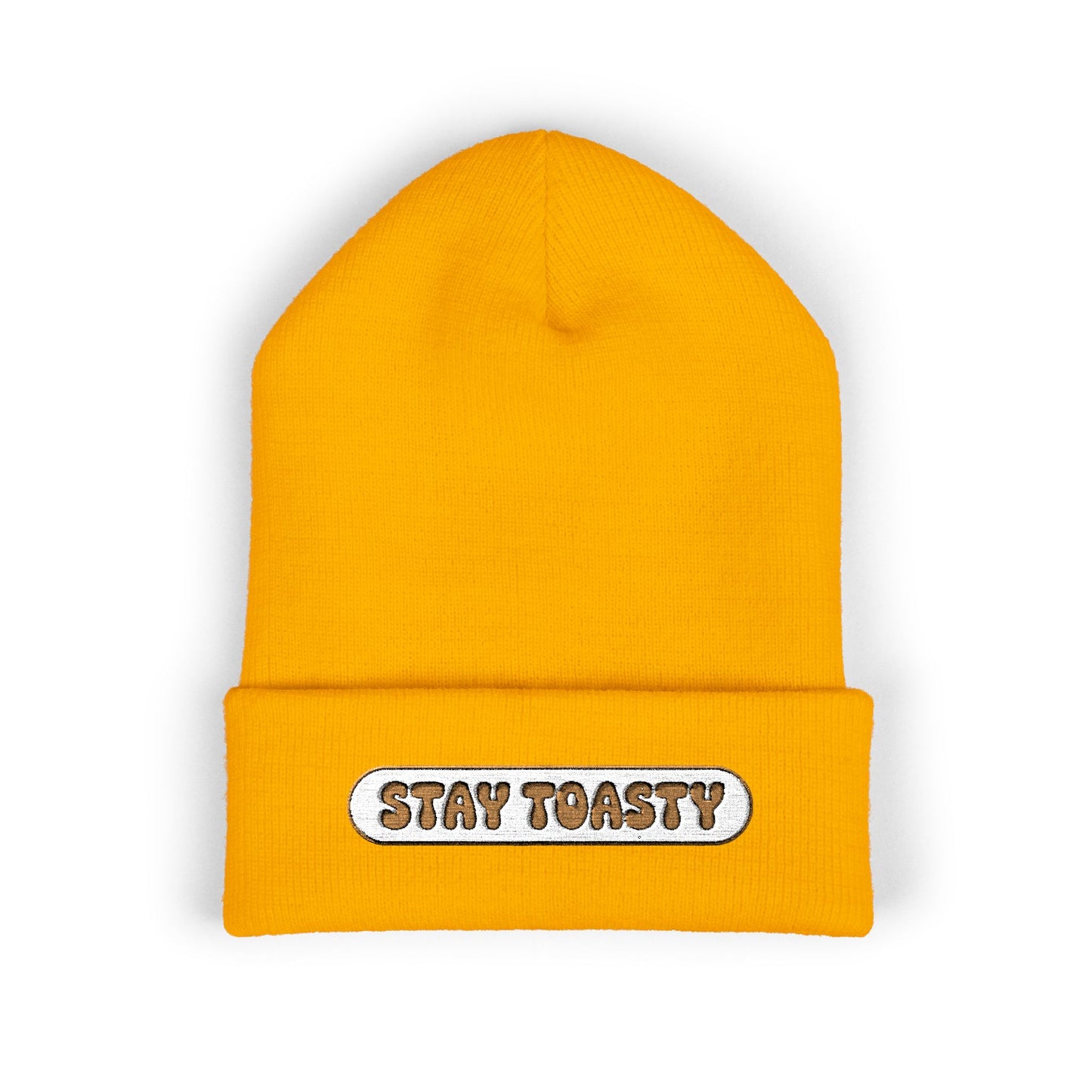 Yellow beanie with 'Stay Toasty' label on a white background
