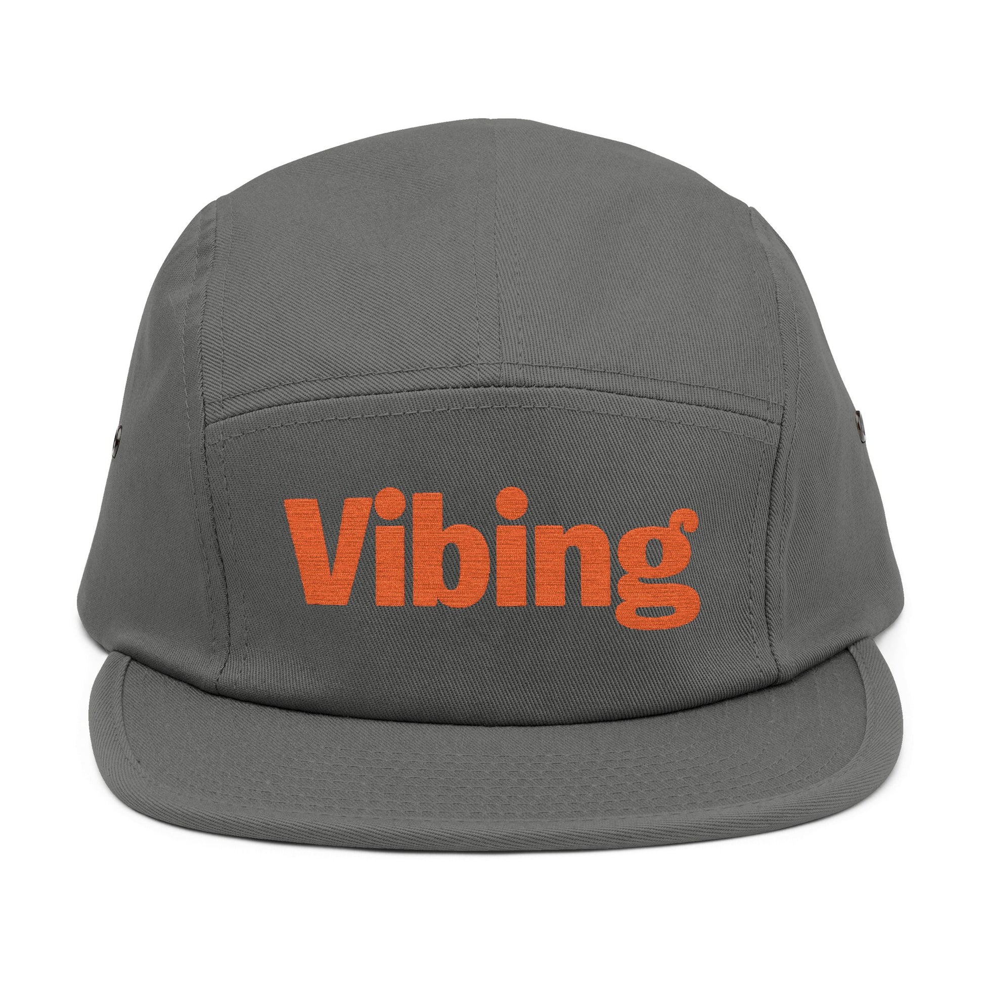 Gray cap with 'Vibing' text in orange on a white background. Close-up of “Vibing” premium embroidery for streetwear style. TEEZOCA