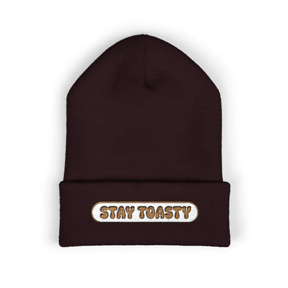 Brown beanie with 'Stay Toasty' text on a white background