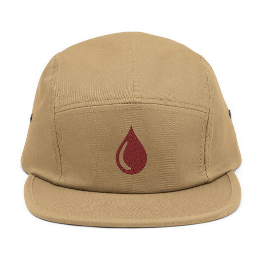 Beige cap with a red droplet symbol on a white background. Minimal coffee drop icon embroidered in a clean, modern style 5-panel cap. TEEZOCA