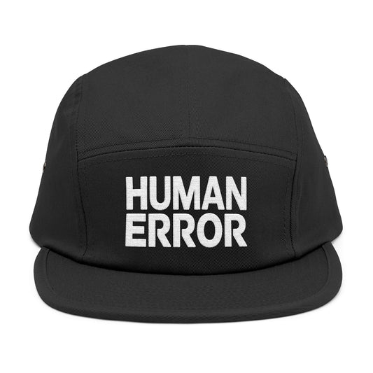 Black cap with 'HUMAN ERROR' text on a white background. . Front view of an embroidered 5-panel cap featuring the bold “HUMAN ERROR” typography in white. TEEZOCA